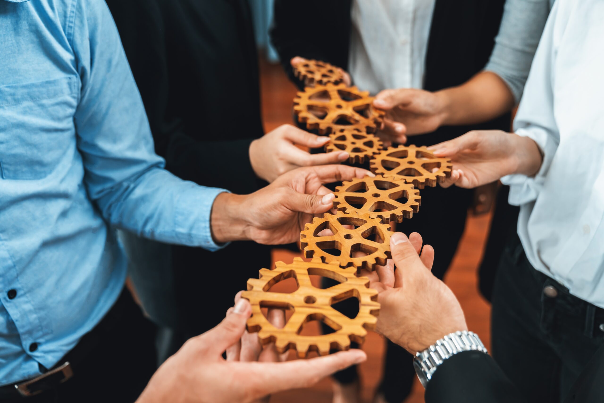 Group,Of,Multiracial,Business,People,Joining,Gear,Wheels,Together,As